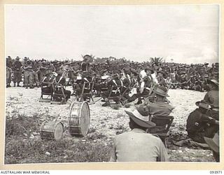 WUNUNG PLANTATION, JACQUINOT BAY, NEW BRITAIN, 1945-07-11. THE BAND OF THE 29/46 INFANTRY BATTALION COMPETING IN THE FINAL OF THE CONTEST IN THE DIVISION COMPETITIONS