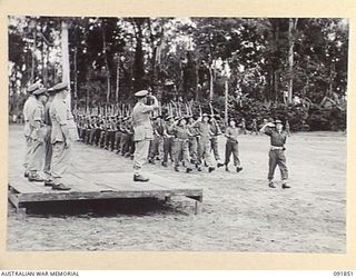 TOROKINA, BOUGAINVILLE. 1945-05-11. LIEUTENANT GENERAL V.A.H. STURDEE, GENERAL OFFICER COMMANDING FIRST ARMY (1), TAKING THE SALUTE DURING THE MARCH PAST BY TROOPS OF 25 INFANTRY BATTALION (A.I.F.)
