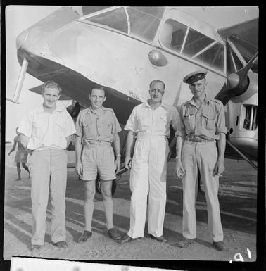 Qantas Empire Airways' personnel (left to right), Mr R Haughey, Traffic Officer, Mr E Loney, AERA engineer, Mr K Whiteman, Traffic Officer, and Mr F Furness, pilot, Lae, Morobe, Papua New Guinea