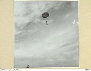 NADZAB, NEW GUINEA. 1944-07-21. A STORPEDO CONTAINING STORES AND PROVISIONS DROPPED BY PARACHUTE TO PERSONNEL AT HEADQUARTERS NEW GUINEA FORCE. NOTE THE POINTED PERCUSSION NOSE WHICH BURSTS AS THE ..