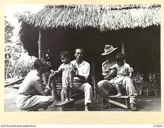 BASU RIVER VALLEY, NEW GUINEA. 1944-05-14. SETO KONG (3), WITH HIS TWO SONS AND ALLIED FRIENDS IN A CHINESE FARMING VILLAGE SITUATED APPROXIMATELY 7 MILES FROM LAE. IDENTIFIED PERSONNEL ARE:- ..