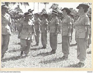 LAE, NEW GUINEA. 1945-10-22. LIEUTENANT COLONEL M.J. SPENCER, ASSISTANT CONTROLLER AUSTRALIAN WOMEN'S ARMY SERVICE (2) AND STAFF SERGEANT B. YOUNG (1), INSPECTING AUSTRALIAN WOMEN'S ARMY SERVICE ..