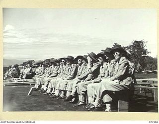 LAE, NEW GUINEA. 1944-04-23. MEMBERS OF THE 2/7TH GENERAL HOSPITAL, AUSTRALIAN ARMY NURSING SERVICE AWAITING COMMENCEMENT OF THE DEDICATION CEREMONY AT THE LAE WAR CEMETERY CONDUCTED BY NX8 ..