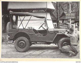 PALMALMAL PLANTATION, JACQUINOT BAY, NEW BRITAIN, 1945-06-06. CRAFTSMAN V. RYAN, 1 INFANTRY TROOPS WORKSHOP PAINTING AN ARMY NUMBER OF A FINISHED JEEP. IT IS THE FINAL STATE OF 'WILLOW RUN', AN ..