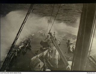 At sea. Great Australian Bight. c. 1942. Spray covers the bow of the RAN HMAS Moresby as she ploughs through the sea, probably between 1941-12 and 1943, while she was patrolling waters around the ..
