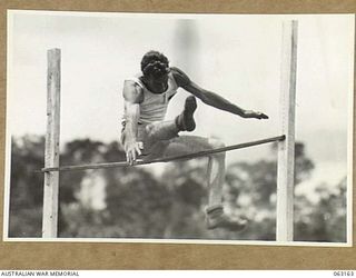 DONADABU, PAPUA, NEW GUINEA. 1944-01-01. VX109936 SERGEANT C.D. BROWN CLEARING 5' 1" TO WIN THE HIGH JUMP EVENT AT THE 15TH INFANTRY BRIGADE GYMKHANA