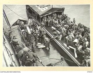 MILFORD HAVEN, LAE, NEW GUINEA. 1944-10-06.TROOPS OF THE 36TH INFANTRY BATTALION MOVING UP THE GANGWAY OF THE DUTCH TROOPSHIP, "SWARTENHONDT" FOR THE UNIT'S MOVE TO NEW BRITAIN