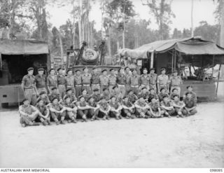 Group portrait of personnel of B Squadron Workshops, 2/4th Armoured Regiment. Left to right, back row: WX15030 Craftsman (Cfn) J L McDonald of Cottesloe, WA; WX7535 Cfn E C Vickers of Nadington, ..