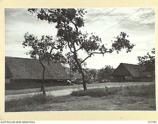 PORT MORESBY, NEW GUINEA. 1944-05-01. THE HUT ON THE LEFT IS THE POST OFFICE, HEADQUARTERS NEW GUINEA FORCE. THE FAR HUT IS USED AS A REGIMENTAL AID POST AND DENTAL CLINIC