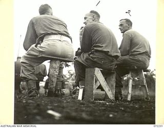 KILIGIA, NEW GUINEA. 1944-04-10. NX28629 PRIVATE E.C. MACKAY (1), WITH NX47810 PRIVATE R. BUCHANAN (2), AWAITING COMMENCEMENT OF THE UNIT MOVIE "CHARLEY'S AUNT", ON A VARIED COLLECTION OF SEATS AT ..