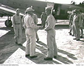 THE SOLOMON ISLANDS, 1945. AMERICAN MAJOR GENERAL R.J. MITCHELL BEING FAREWELLED BY US SERVICE PERSONNEL PRIOR TO BOARDING AN US C47 AIRCRAFT ON HIS DEPARTURE FROM BOUGAINVILLE ISLAND