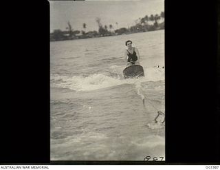 MADANG, NEW GUINEA. 1944-12-27. 500288 SISTER J. MESLEY, LEONGATHA, VIC, HAS PROVED AN ADEPT PUPIL OF THE DIFFICULT SPORT OF AQUAPLANING. AFTER A HARD DAYS WORK THE NURSES COOL OFF IN THIS NEARBY ..