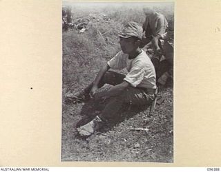 KAIRIRU ISLAND, NEW GUINEA, 1945-09-11. JAPANESE NAVAL MAN WHO HAS STYLED HIMSELF A PAIR OF CANVAS AND ROPE SHOES. JAPANESE NAVAL PERSONNEL ARE BEING TRANSFERRED FROM KAIRIRU TO MUSHU ISLAND. ..