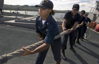 U.S. Navy PETTY Officer 2nd Class Chelsea McCalop, Information Systems Technician, retrieves a mooring line, as the Arleigh Burke Class Guided Missile Destroyer USS HOPPER (DDG 70) departs Guam on Sep. 6, 2006. The HOPPER is on a scheduled deployment in support of Maritime Security Operations and the Global War On Terrorism.(U.S. Navy photo by Mass Communication SPECIALIST Second Class John L. Beeman) (Released)