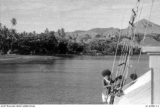 1942-09-09. THE SCHOONER "MACLAREN KING" WHICH ACTS AS A FERRY BETWEEN THE ISLAND AND NEW GUINEA, APPROACHING THE ANGLICAN MISSION STATION AT DOGURA. (NEGATIVE BY BOTTOMLEY)