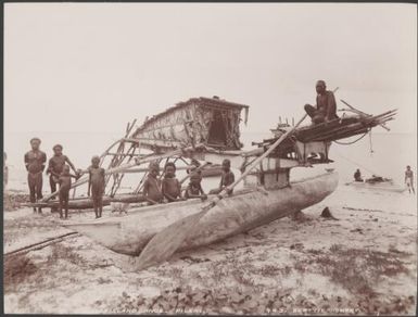 Men and children gathered around a canoe on a beach at Pileni, Reef Islands, 1906 / J.W. Beattie