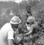 Group portrait, anthropologist and children in garden