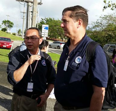 Guam, May 17, 2015 - Guam Civil Defense Deputy Coordinating Officer Leo Esia (left) and Deputy Region 9 IMAT leader Mark Armstrong brief Guam and FEMA officials on response strategies for Typhoon Dolphin.