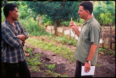 Two men talking in a vegetable garden,Tonga