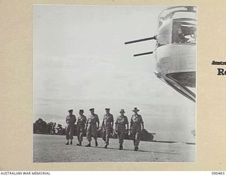 JACQUINOT BAY, NEW BRITAIN. 1945-04-09. SENATOR J.M. FRASER, ACTING MINISTER FOR THE ARMY (1), AND OFFICIAL PARTY, EXAMINING THE AIRSTRIP BUILT FOR THE RAAF BY MEN OF 5 DIVISION