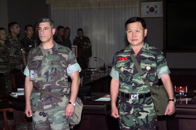 Commanding General, Marine Forces Pacific, Camp H. M. Smith, Hawaii, Lieutenant General Frank Libutti stands with Lieutenant General Kim Myung Kwan, Commandant of Republic of Korea Marine Corps, as they prepare to pass the operational colors for Exercise ULCHI FOCUS LENS 2000. "ULCHI FOCUS LENS, held since 1976, is a computer-simulated, command-post exercise held to evaluate and improve operations in the defense of South Korea. There is no field training."