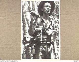 GUY'S POST, FARIA RIVER AREA, NEW GUINEA. 1943-11-08. NX37260 SERGEANT G. H. JEFFERY OF WOOLONGONG, NSW, AND OF THE 2/33RD AUSTRALIAN INFANTRY BATTALION MOVING TO GUY'S POST TO RELIEVE MEMBERS OF ..