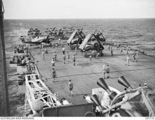 AT SEA OFF RABAUL, NEW BRITAIN. 1945-09-06. FLIGHT CREWS PREPARING CORSAIR AND BARRACUDA AIRCRAFT ON THE FLIGHT DECK OF THE AIRCRAFT CARRIER HMS GLORY BEFORE TAKE OFF. THEY WILL CIRCLE OVERHEAD ..