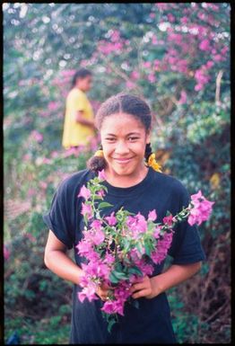 Young woman holding pink flowers,Tonga