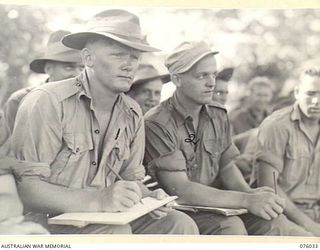 MADANG, NEW GUINEA. 1944-09-17. NX125201 CORPORAL T.W. REID, 165TH GENERAL TRANSPORT COMPANY (1) AND VX64976 TROOPER W.T HURLEY, 2/4TH FIELD SQUADRON (2), THE SCORERS FOR THE CRICKET MATCH BETWEEN ..