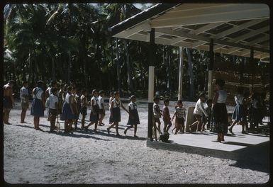 Children entering school building on Palmerston Island, Cook Islands