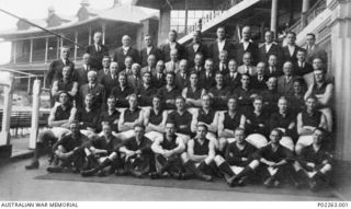 Melbourne, VIC. 1940-09. Outdoors group portrait of members of the Melbourne Football Club team with club officials at the Melbourne Cricket Ground, after the team had won the 1940 Victorian ..