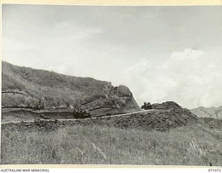 FINISTERRE RANGES, NEW GUINEA. 1944-03-15. THE GRADED ROAD FROM EVAPIA RIVER TO KESAWAI NEAR THE EVAPIA RIVER. THE ROAD ELIMINATES SUPPLY CARRYING BY NATIVES TO KESAWAI AND BEYOND