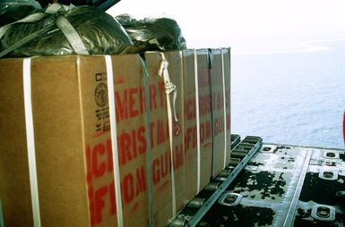 Containers filled with packages stand on rollers prior to being airdropped from the back of a 374th Tactical Airlift Wing C-130 Hercules aircraft during Christmas Drop mission. The annual airdrop is a humanitarian effort providing aid to needy islanders throughout Micronesia during the holiday season