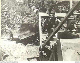 BOUGAINVILLE ISLAND. 1945-02-04. A BULLDOZER OF THE 5TH FIELD COMPANY, BEING USED TO SALVAGE A BOGGED 3 TON TRUCK LOADED WITH SOIL DURING THE REPAIRING OF THE MAWARAKA- MOSIGETTA ROAD