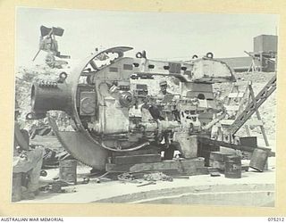 PORT MORESBY, PAPUA, 1944-08-17. GUNNERS WORKING ON THE INSTALLATION OF THE CRADLE OF NO. 1 GUN (5.25) AT THE BASILISK BATTERY OF THE 801ST ANTI AIRCRAFT AND COAST ARTILLERY BATTERY