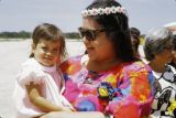 Federated States of Micronesia, woman holding child at airport on Pohnpei Island