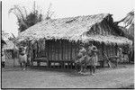 Tinami, inland Bunabun: women and children next to building, probably mission clinic