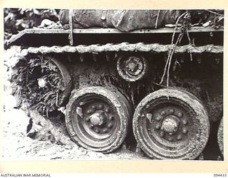 TOROKINA AREA, BOUGAINVILLE. 1945-07-28. THE OFF SIDE TRACKS OF AN M24 GENERAL CHAFFEE LIGHT TANK AFTER 3 HOURS 18 MINUTES IN DENSE JUNGLE DURING TESTS CONDUCTED FOR THE WAR OFFICE