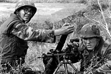Corporal D. M. Laker and Lance Corporal K. L. Wally, Weapons Co., 3rd Bn., 3rd Marines, 1ST Marine Bde., prepare to fire an M224 60 mm lightweight company mortar during Operation KERNAL BLITZ