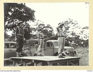 POM POM VALLEY, NEW GUINEA, 1944-02-16. NX8 LIEUTENANT-GENERAL SIR LESLIE J. MORSHEAD, KCB., KBE., CMG., DSO., ED., (3) GENERAL-OFFICER-COMMANDING NEW GUINEA FORCE, TAKES THE SALUTE AT THE FAREWELL ..