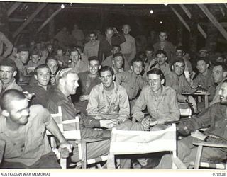 JACQUINOT BAY, NEW BRITAIN. 1945-02-03. THE NEW YOUNG MEN'S CHRISTIAN ASSOCIATION COMFORTS FUND SERVICES CLUB CROWDED WITH SERVICE PERSONNEL ON THE OPENING NIGHT. THE HUT WAS OFFICIALLY OPENED BY ..