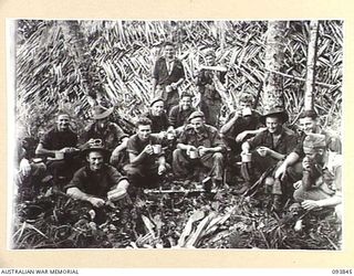 YAMIL AREA, NEW GUINEA, 1945-07-06. MEMBERS OF 17 PLATOON, D COMPANY, 2/5 INFANTRY BATTALION, HAVING A CUP OF TEA ON ARRIVAL AT ULUPU, THEIR NEW POSITION, AFTER AN ARDUOUS TREK FROM AMUWIMBILL. THE ..