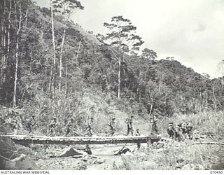 FARIA RIVER, NEW GUINEA, 1944-02-15. MEMBERS OF "A" COMPANY OF THE 57TH/60TH INFASNTRY BATTALION CROSSING A BRIDGE IN THEIR MARCH UP THE FARIA RIVER TO RELIEVE THE 2/9TH INFANTRY BATTALION AT THE ..