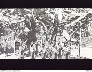 RABAUL, NEW BRITAIN, 1945-12-17. THE TURNING OUT OF THE GUARD BY MEMBERS OF 1ST NEW GUINEA INFANTRY BATTALION DURING TRAINING CONDUCTED BY THE AUSTRALIAN ARMY EDUCATION SERVICE