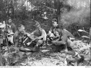 PAPUA, NEW GUINEA. 1942-09. COMMANDING OFFICER OF 2/31ST AUSTRALIAN INFANTRY BATTALION AND SENIOR OFFICERS OF THE BATTALION PHOTOGRAPHED IN THE JUNGLE DURING THE ADVANCE OVER OWEN STANLEY RANGES TO ..