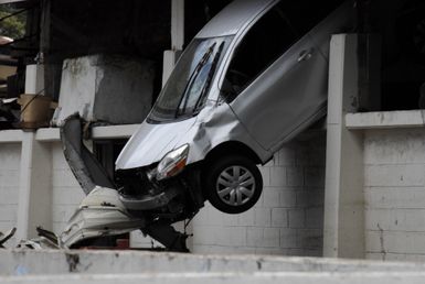 Earthquake ^ Tsunami - Pago Pago, American Samoa, October 1, 2009 -- Pago Pago, American Samoa, October 1, 2009 - A car sits hanging from a upper level parking area. The car was moved by the tsunami that hit American Samoa.