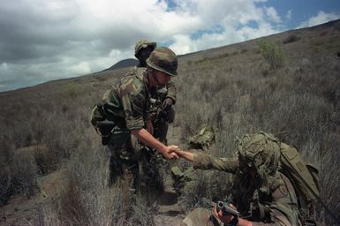 Major General Claude M. Kicklighter, left, commanding general, 25th Infantry Division, meets SPECIALIST Fourth Class (SPC) Jeffrey Goodrich, Company A, 1ST Battalion, 5th Infantry, 25th Infantry Division, during exercise OPPORTUNE JOURNEY 4-84 at Pohakuloa Training Area