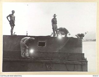 PURUATA ISLAND, SOUTH BOUGAINVILLE. 1945-05-29. PERSONNEL OF 4 WELDING PLATOON WORKING ON THE CONSTRUCTION OF A STEEL CANOPY ON ONE OF 42 LANDING CRAFT COMPANY'S AUSTRALIAN LANDING CRAFT 20'S