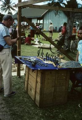 Tourist at black coral carvers stall, Nuku'alofa, June 1984