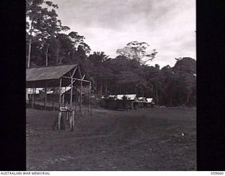SOGERI, NEW GUINEA. 1943-11-04. PARADE GROUND AND BARRACKS OF THE NEW GUINEA FORCE TRAINING SCHOOL. PARTIALLY COMPLETED LECTURE HALL-PICTURE THEATRE CAN BE SEEN ON LEFT